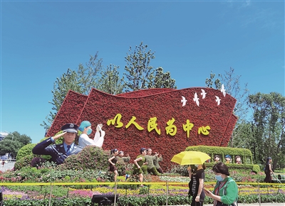 北京市长安街西单路口东北角以写有“以人民为中心”的红旗为主景的花坛。 本报记者 黄秋霞 摄