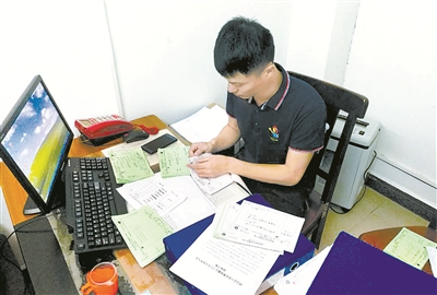 澄迈县委巡察组工作人员正在查看医院药品处方资料。 (资料图片)