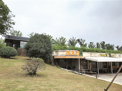 连日来,受长江大流量来水和强降雨影响,秦淮河水位居高不下,南京市一度启动防汛一级应急响应。而就在江宁区杨家圩市民公园旁的秦淮河大堤上,却有几家无规划审批手续的违建餐厅仍在营业。图为7月25日仍在营业的餐厅。任梦岩 摄
